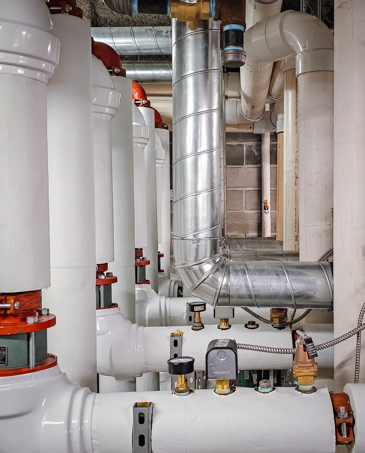 Zion Engineering technician observing commercial HVAC equipment at the start of a service process.