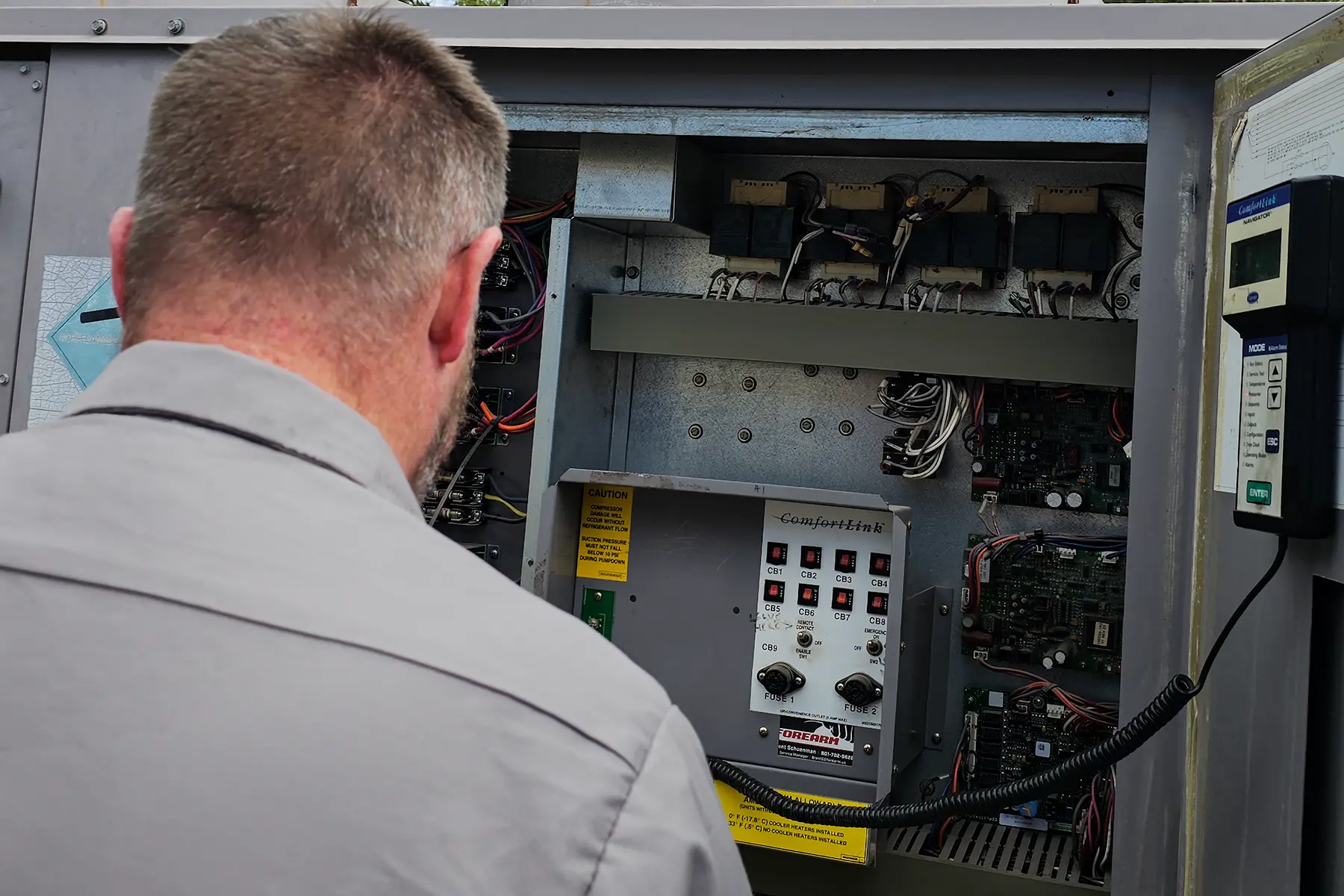 Zion Engineering technician reviewing commercial chiller condition, service history, and replacement requirements with a facility team