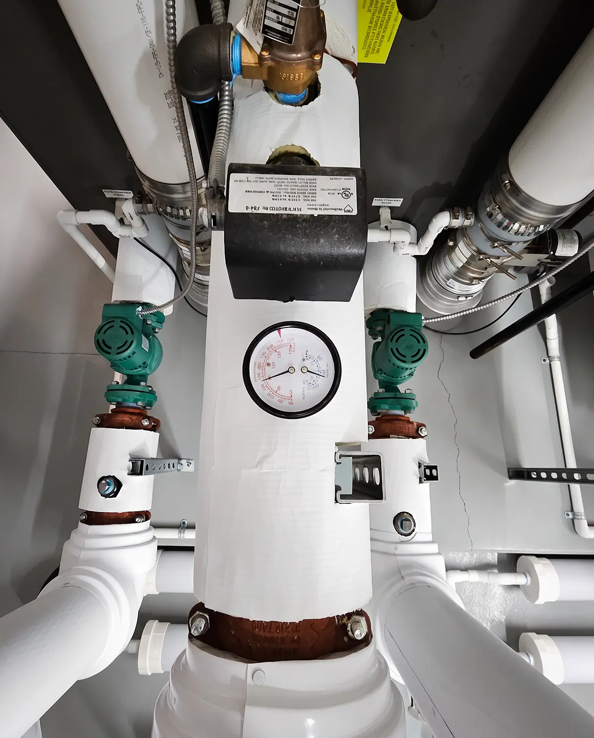 Zion Engineering technician measuring airside and water-side conditions during a commercial mechanical system diagnosis